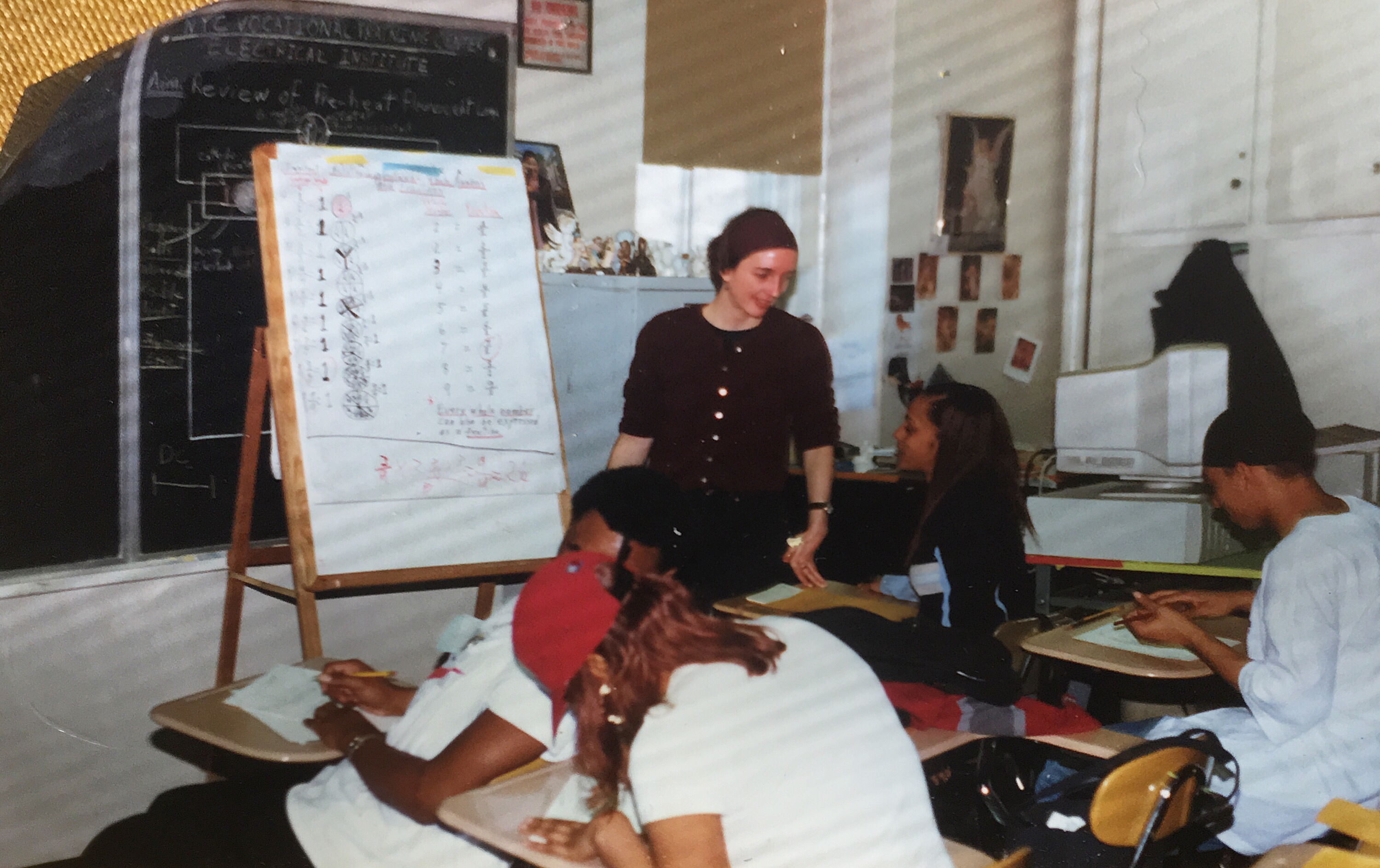 Molly Barker standing. Students seated at their desks.