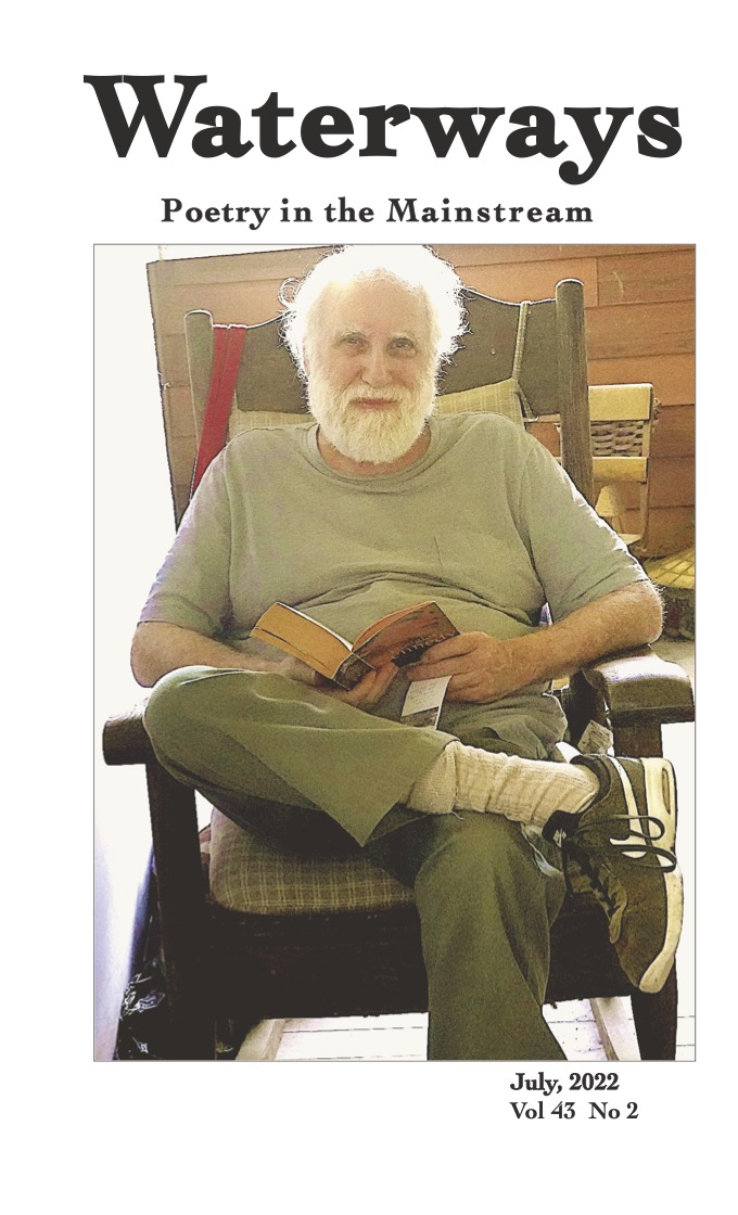 Cover for July shows Richard Spiegel sitting in a rocking chair reading a book